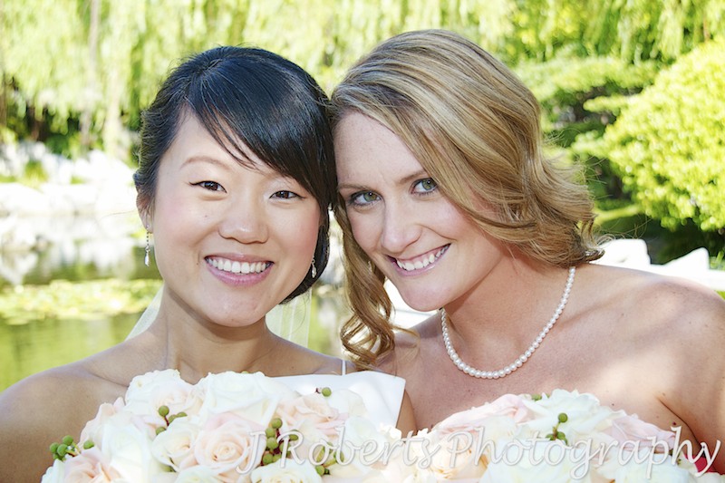 Bride and bridesmaid smiling at camera - wedding photography sydney
